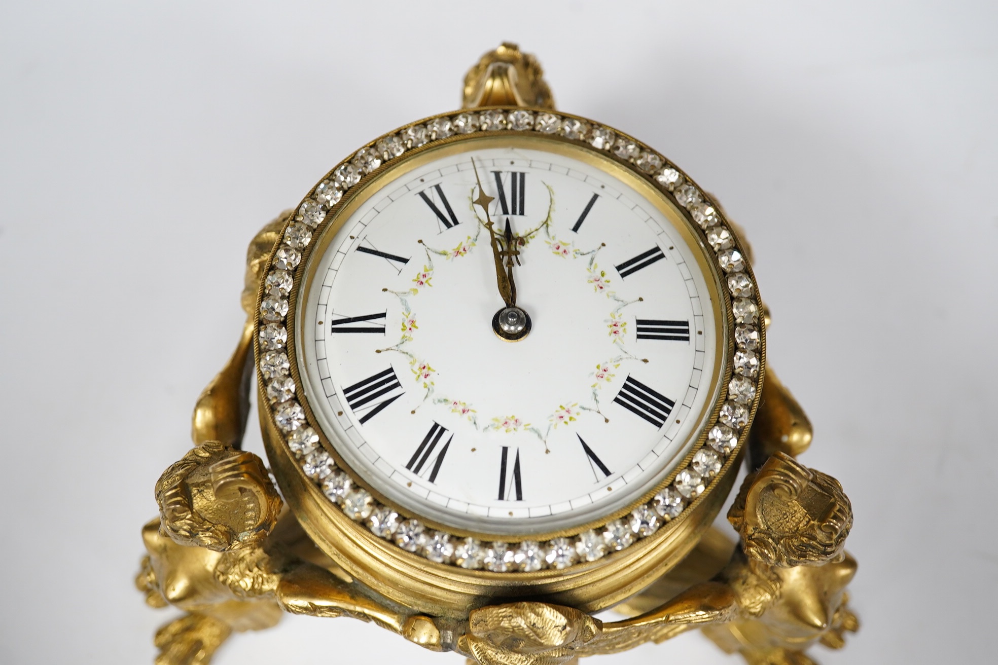 A 19th century French ormolu table timepiece decorated with paste jewelling edged dial and three classical figures, widest point 15cm. Condition - good, not been checked as working